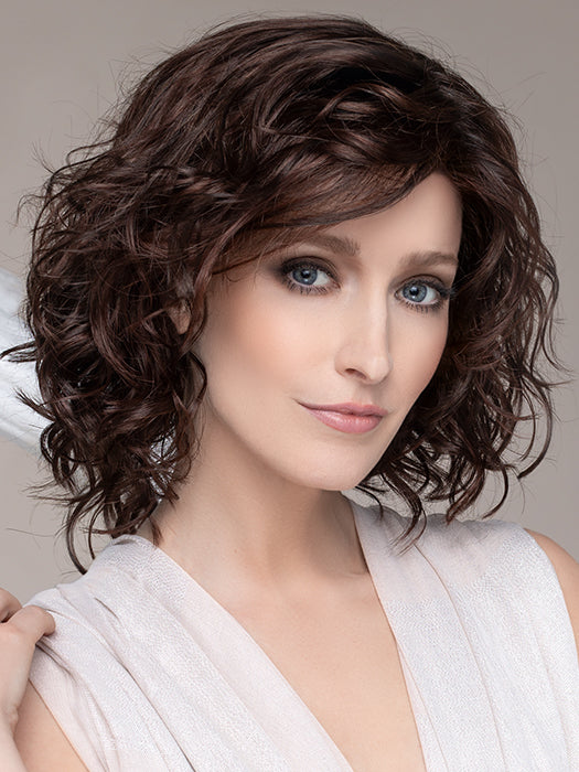 DELICATE PLUS by ELLEN WILLE in DARK CHOCOLATE MIX This image was styled as follows: Curling iron 350°F with a ¾” barrel size, alternating curling directions. Finished by lightly scrunching hair with a small amount of BeautiMark Velvet Spray Gel